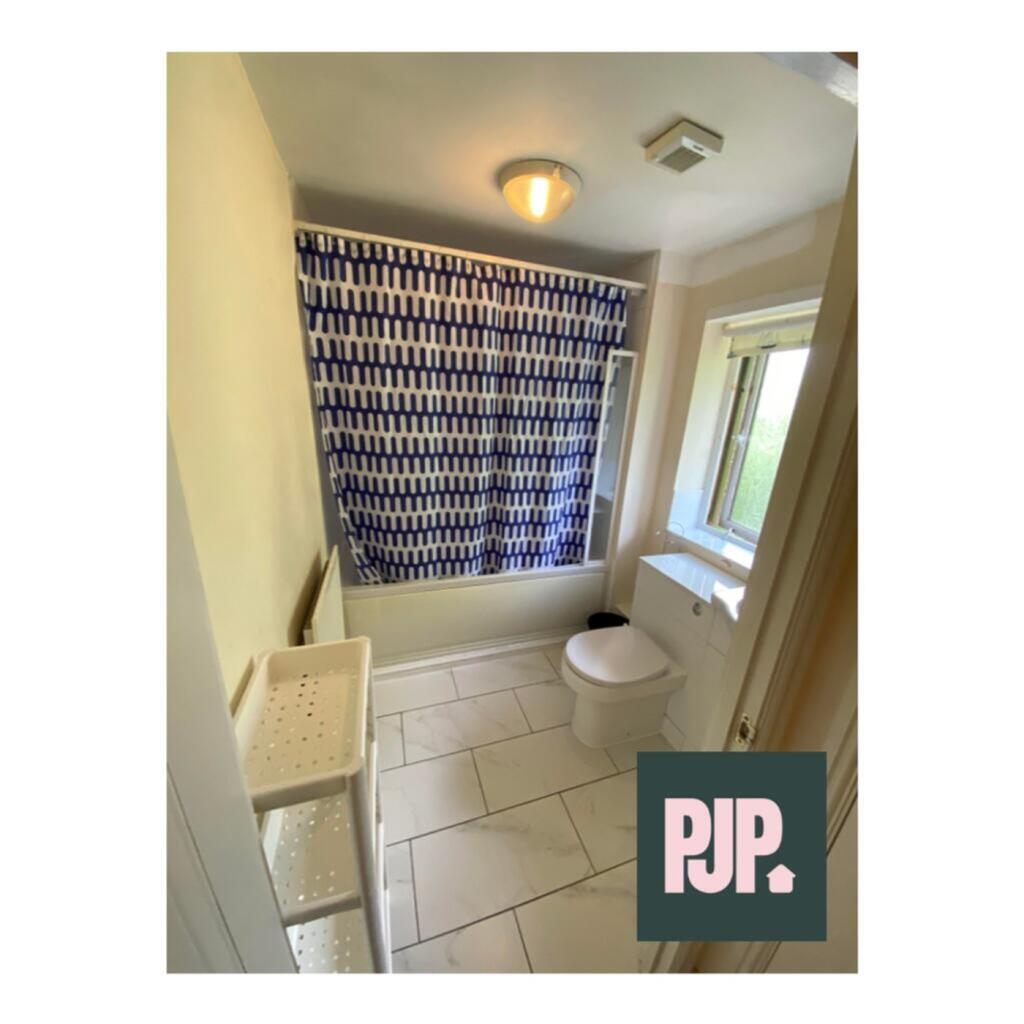 This inviting bathroom features a bright and ai...