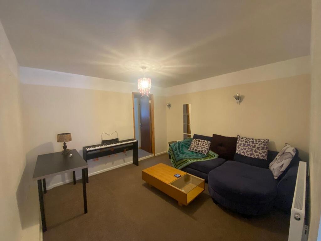 A cozy living room featuring a spacious layout ...