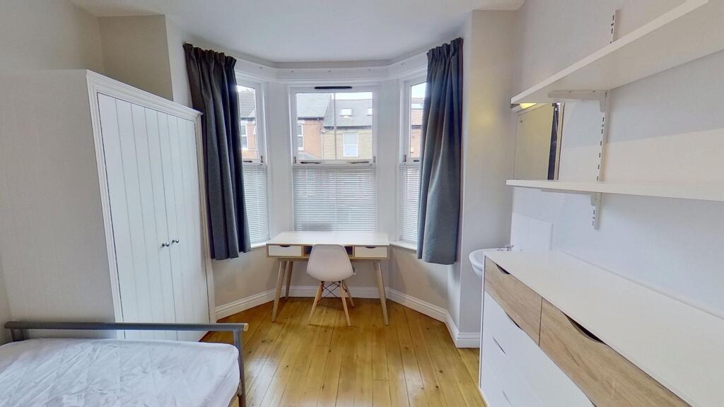 Bright, well-maintained bedroom featuring a lar...