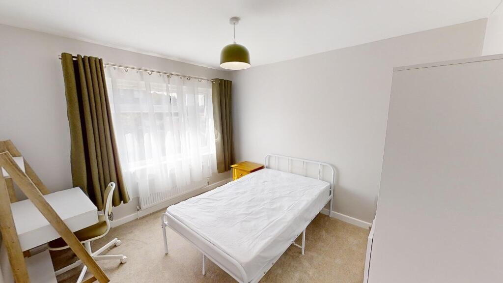 Bright and clean single bedroom featuring a lar...