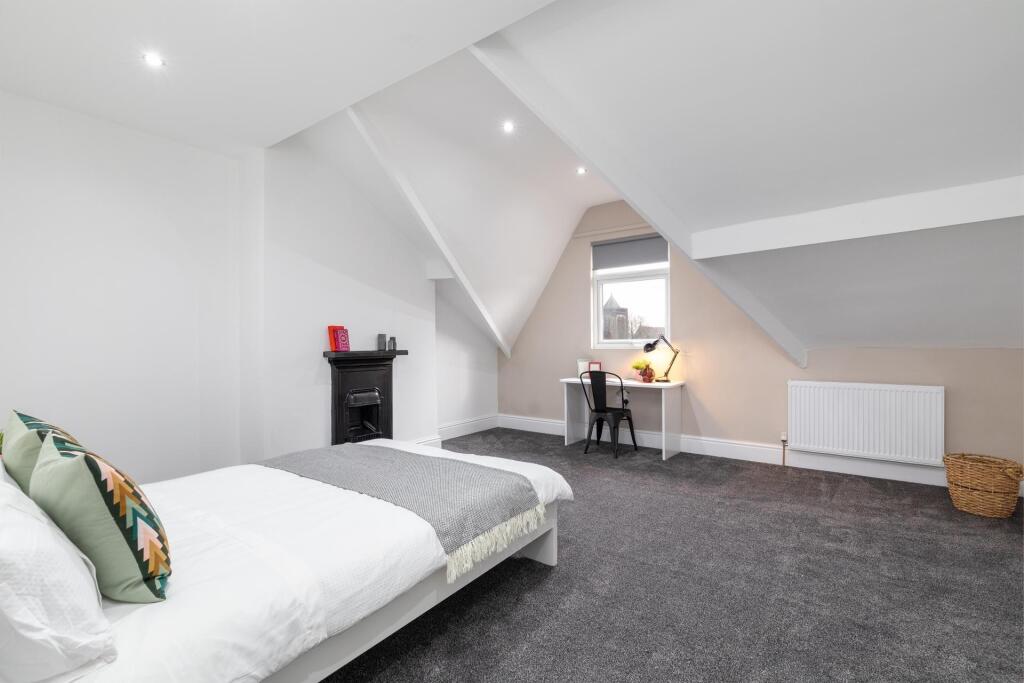 Spacious and bright master bedroom with a large...