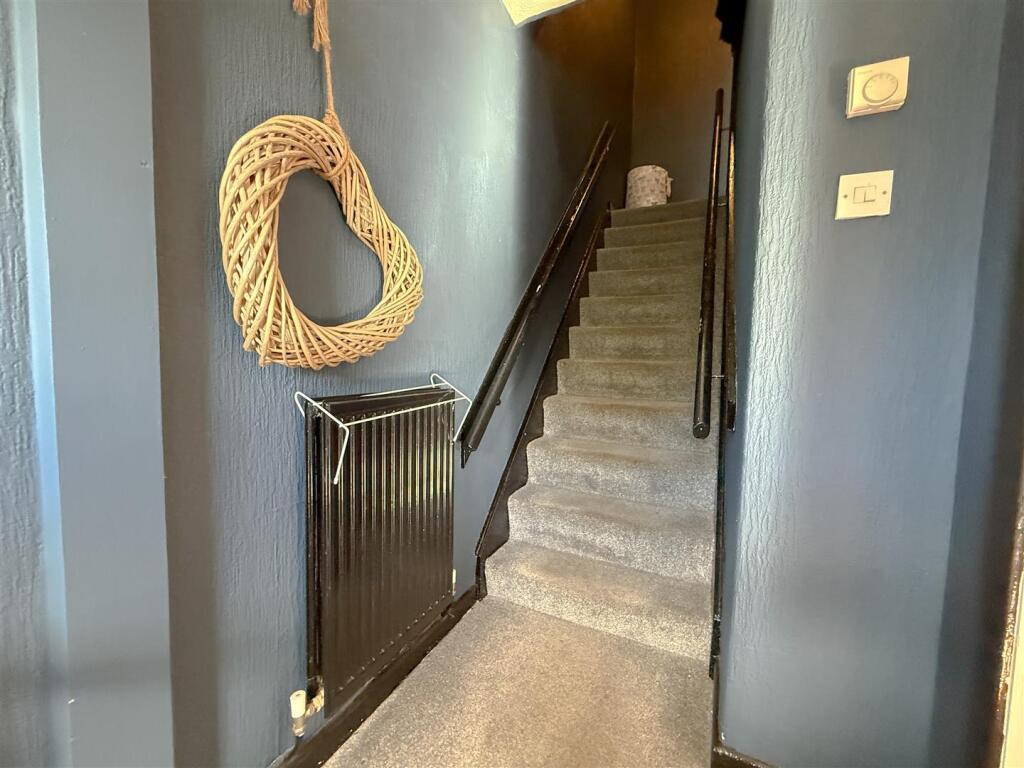 STAIRS RISING TO THE FIRST FLOOR