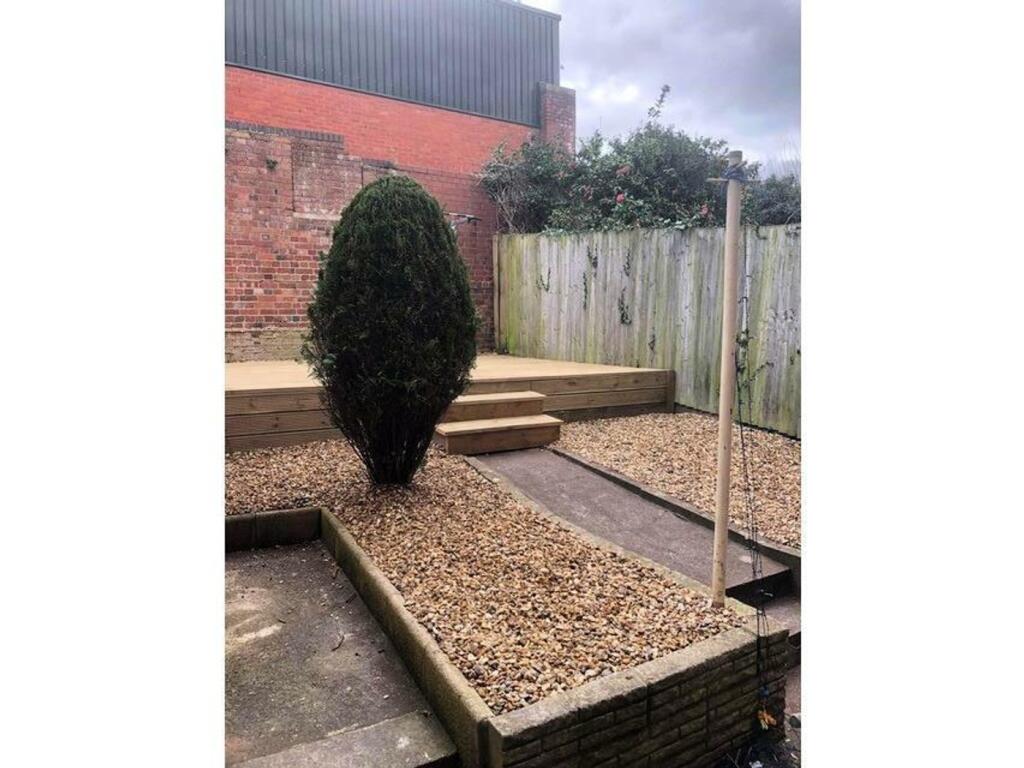 A well-maintained garden area featuring gravel ...