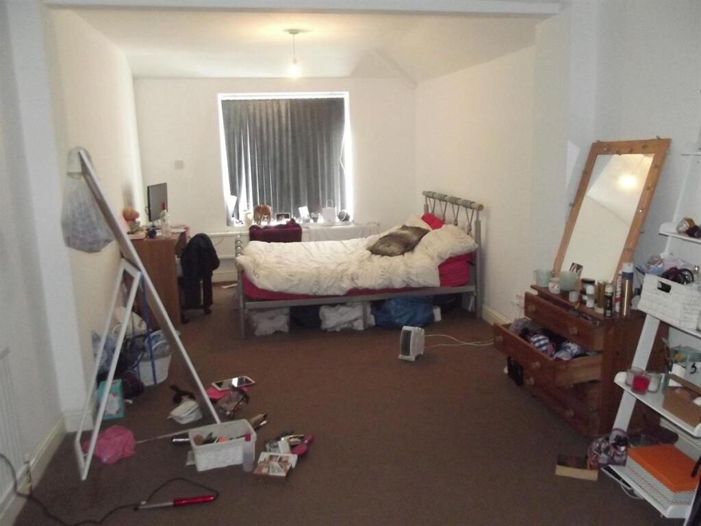 Bright bedroom with a double bed, full-length m...
