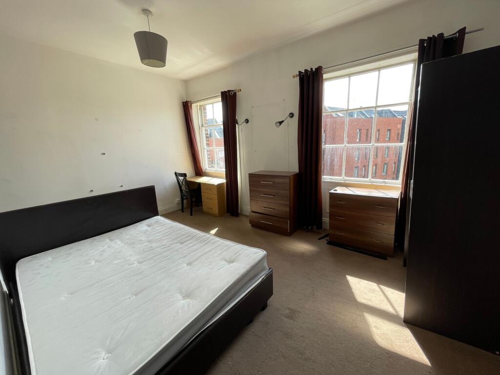 Bright and spacious double bedroom featuring a ...