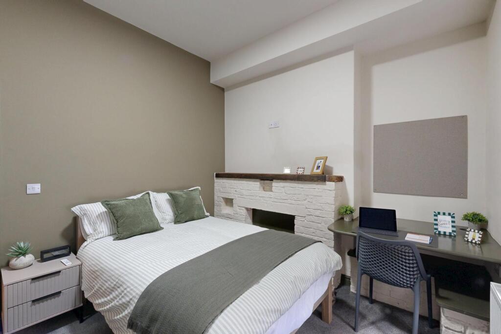 A bright and inviting double bedroom featuring ...