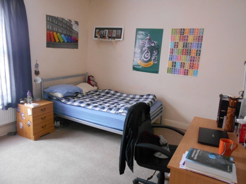 A cozy and tidy bedroom featuring a single bed ...