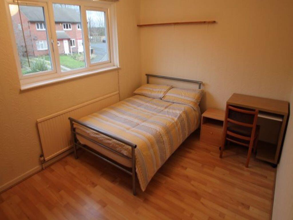 A cozy single bedroom featuring a single bed wi...