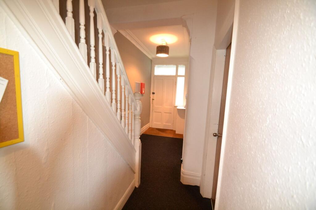 A neat and well-maintained hallway featuring wh...