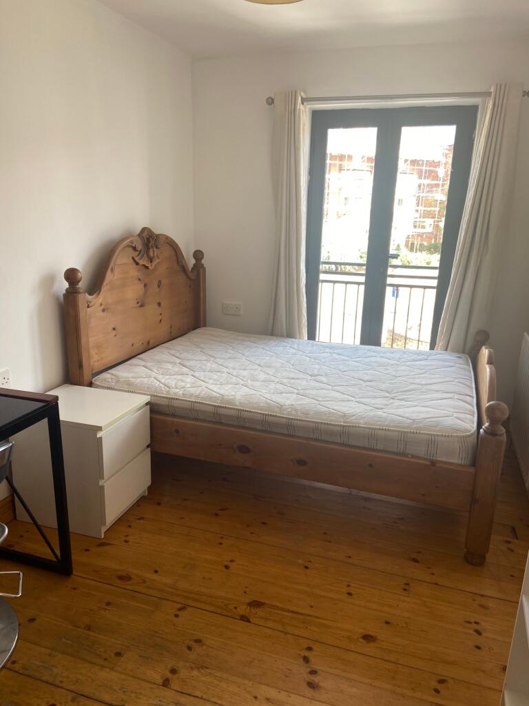 A spacious and bright double bedroom featuring ...