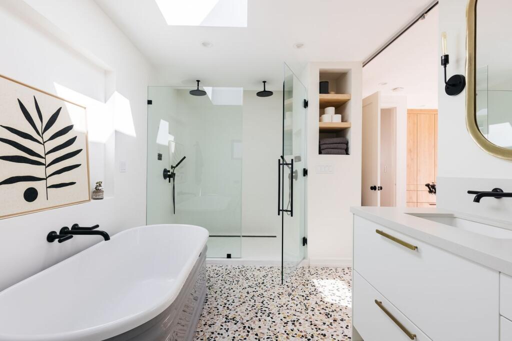 A modern and clean bathroom featuring a bath an...