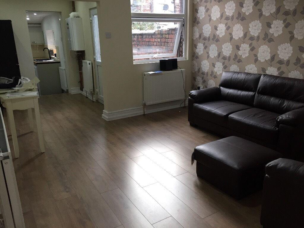 A cozy living room featuring a dark leather sof...