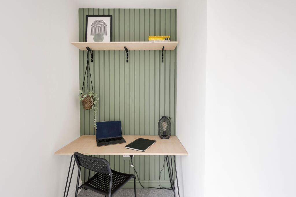 Bright, neatly styled study nook with a light w...