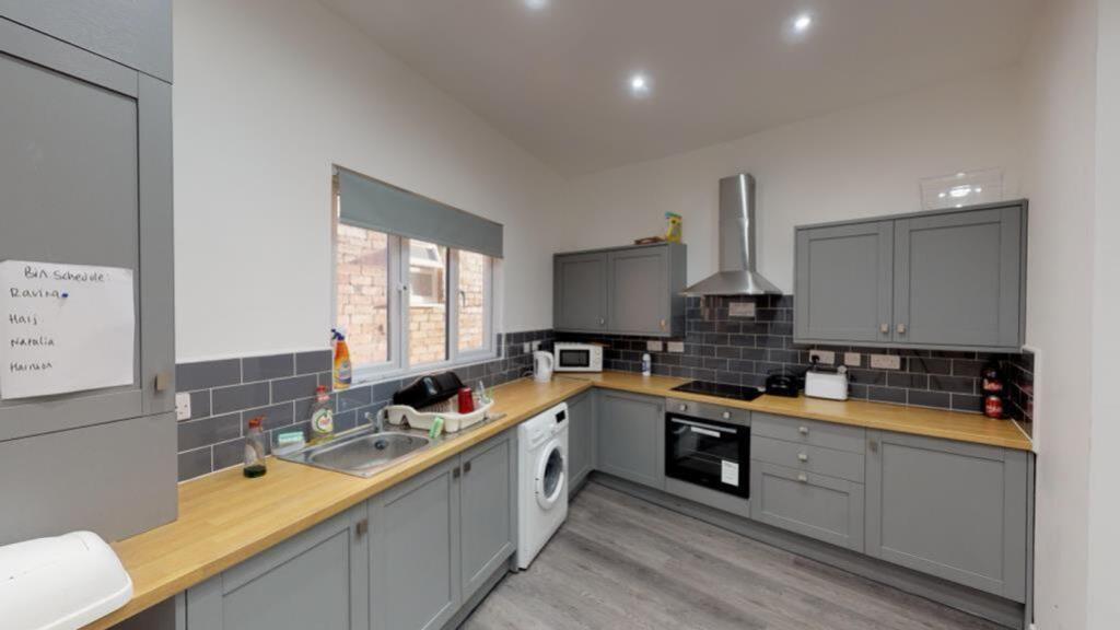 A modern and spacious kitchen equipped with ess...