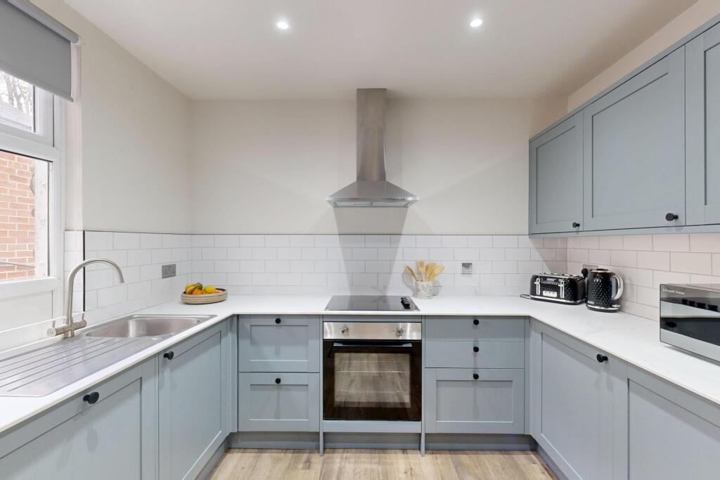 A modern, well-maintained kitchen featuring lig...