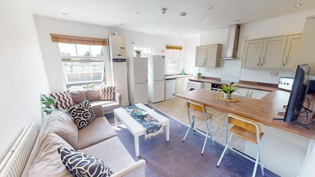 Bright and welcoming living room with a cozy so...