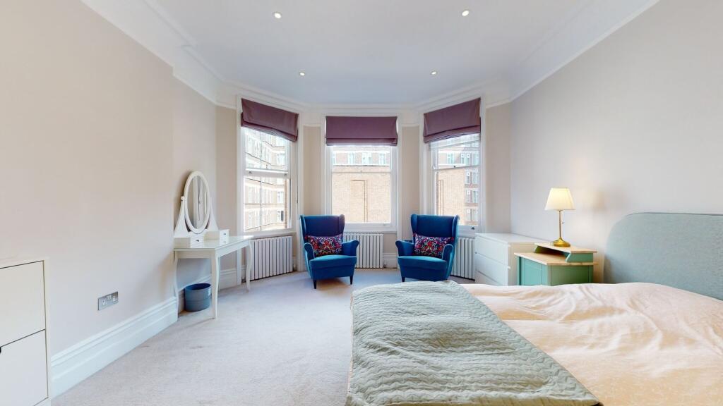 A spacious master bedroom featuring a large dou...