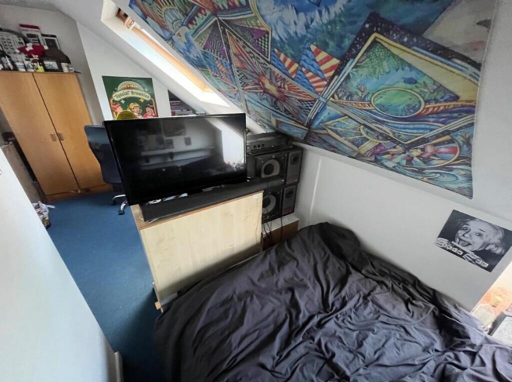 A cozy double bedroom featuring vibrant decor a...