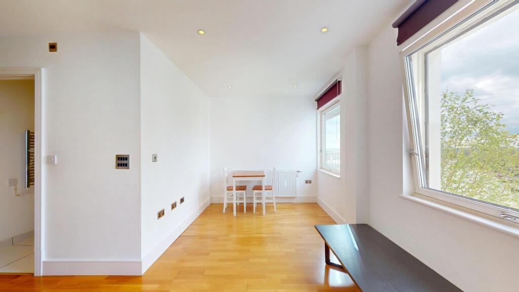 A bright and airy living room with large window...