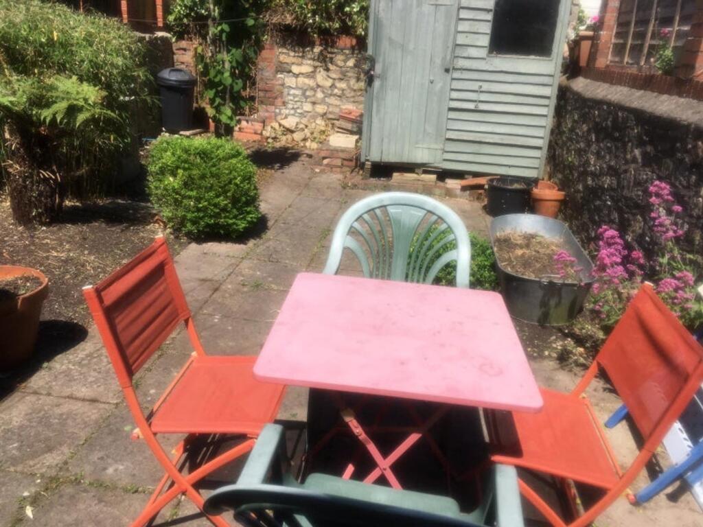 A garden area with a table and chairs, featurin...