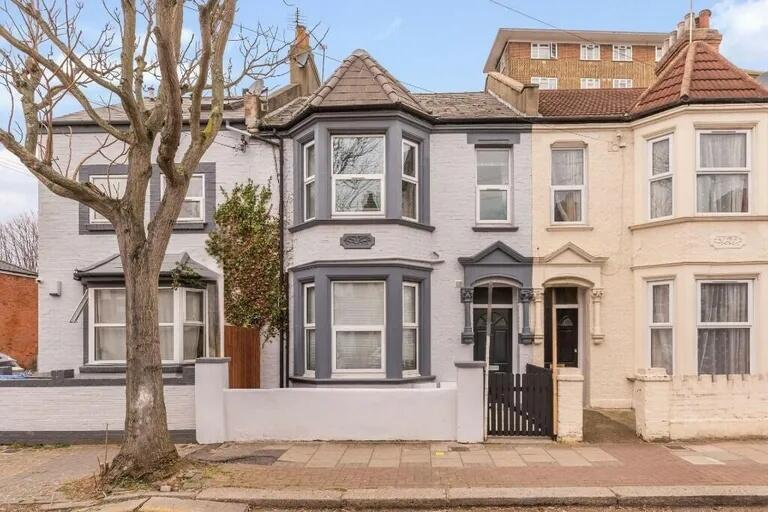 Charming terraced house featuring a classic bay...