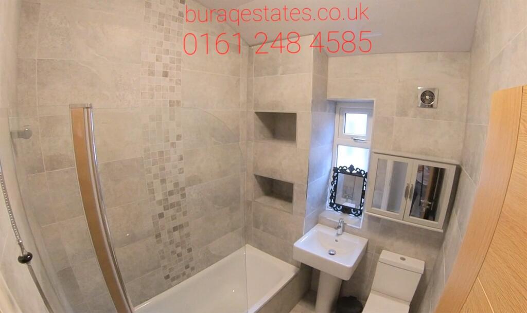 Modern bathroom with a bath and overhead shower...