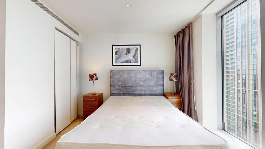 Bright and modern double bedroom featuring a la...