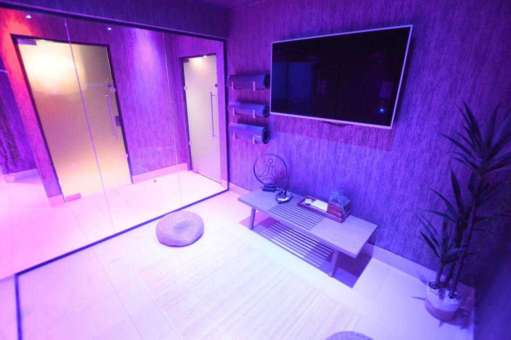 A modern, calming gym space featuring a large w...