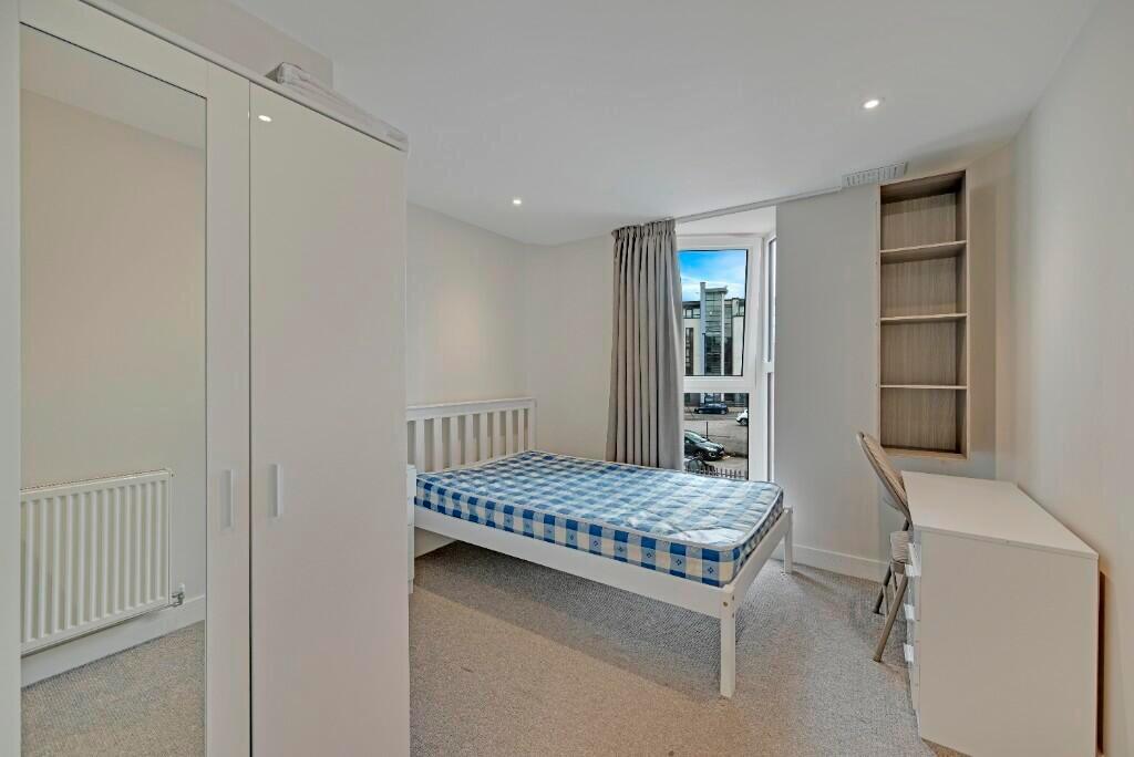 A bright and tidy single bedroom featuring a cl...