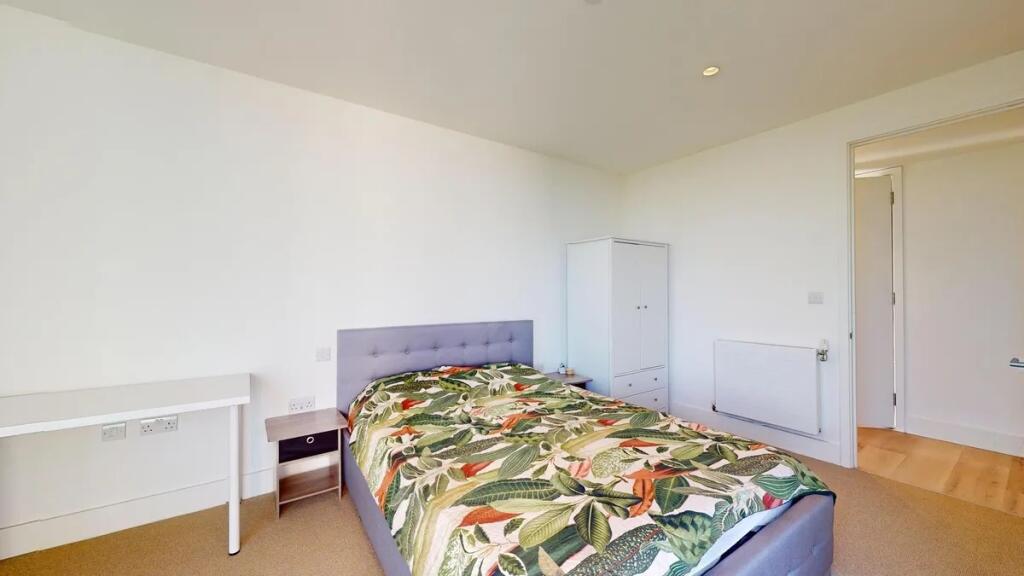 Bright and tidy double bedroom featuring a comf...