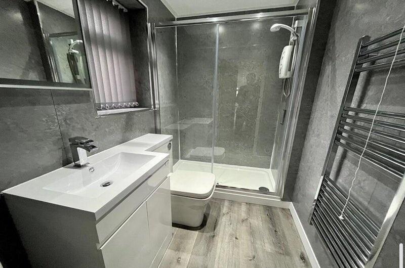 Modern bathroom with a large walk-in shower, sl...