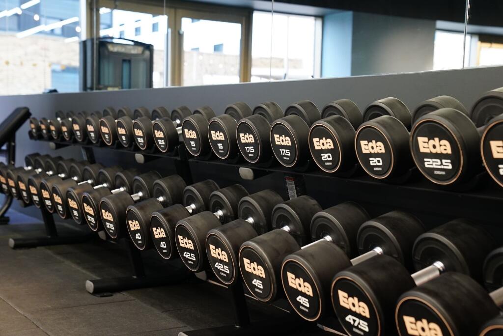 Well-maintained gym space featuring a wide rang...
