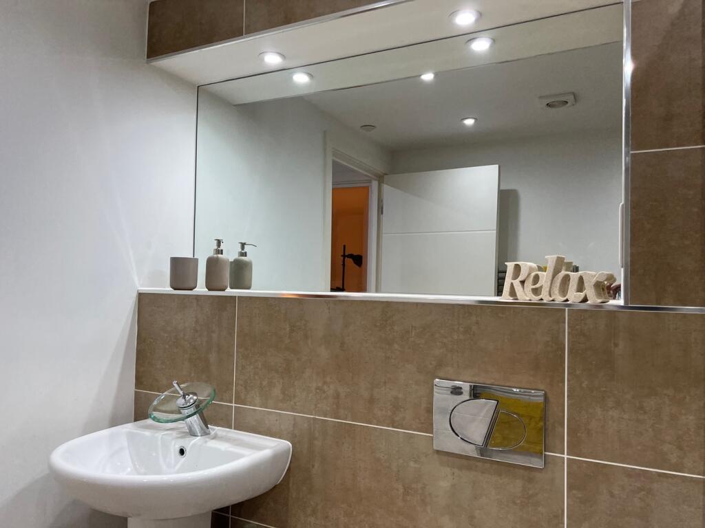 A modern and stylish bathroom featuring elegant...