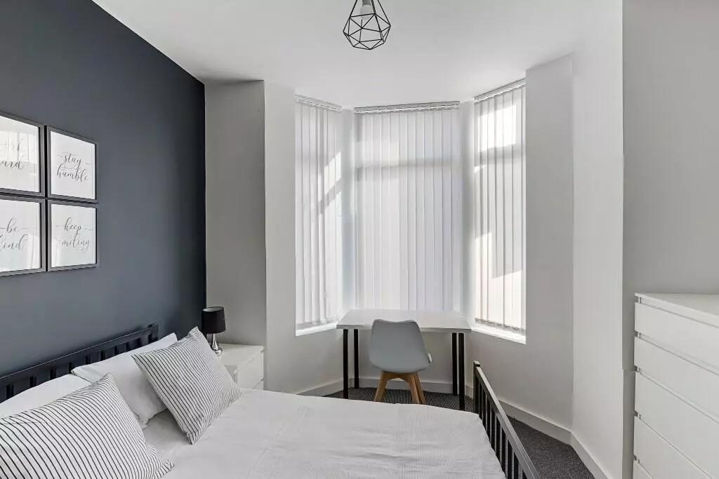 A bright and modern double bedroom featuring a ...