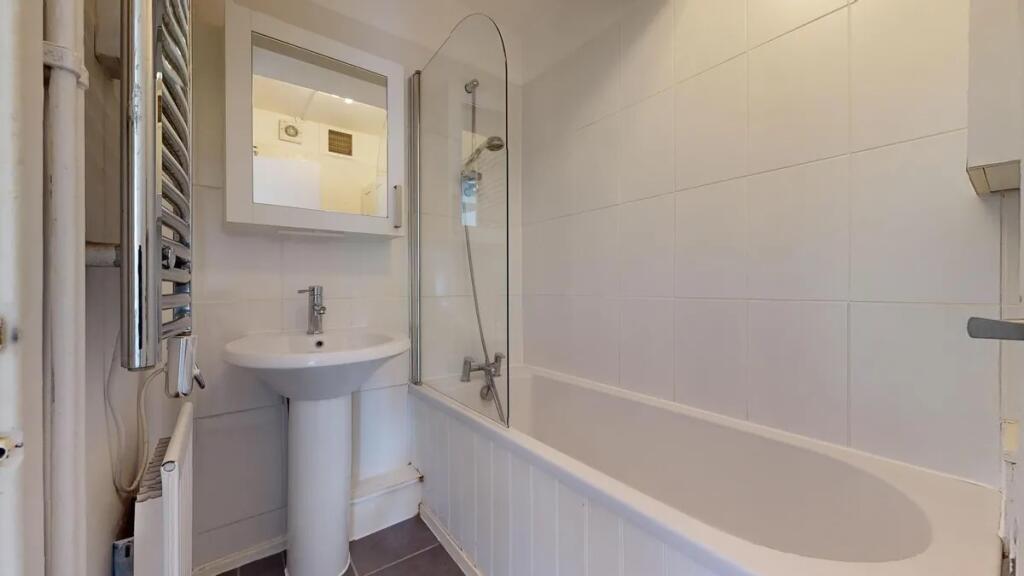 A clean and modern bathroom featuring a white b...