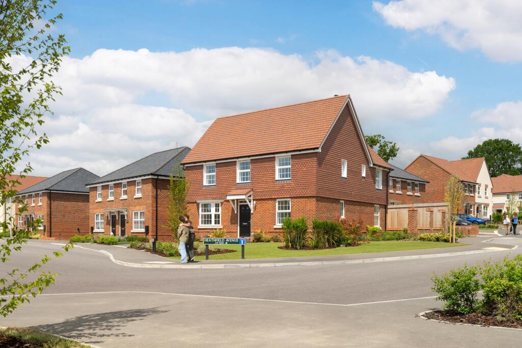 Pedestrians around 3 and 4 bedroom homes at Ersham Park in Hailsham June 25