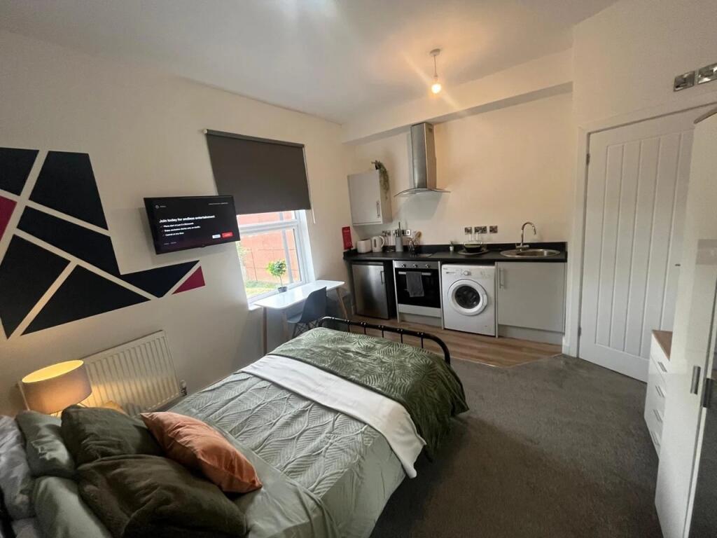 Cozy single bedroom featuring a comfortable bed...