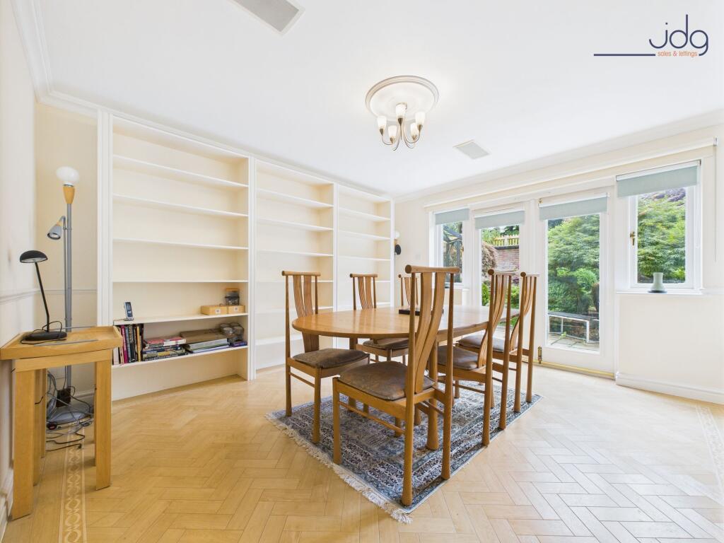 Spacious Dining Room with Built in Shelving and French Doors