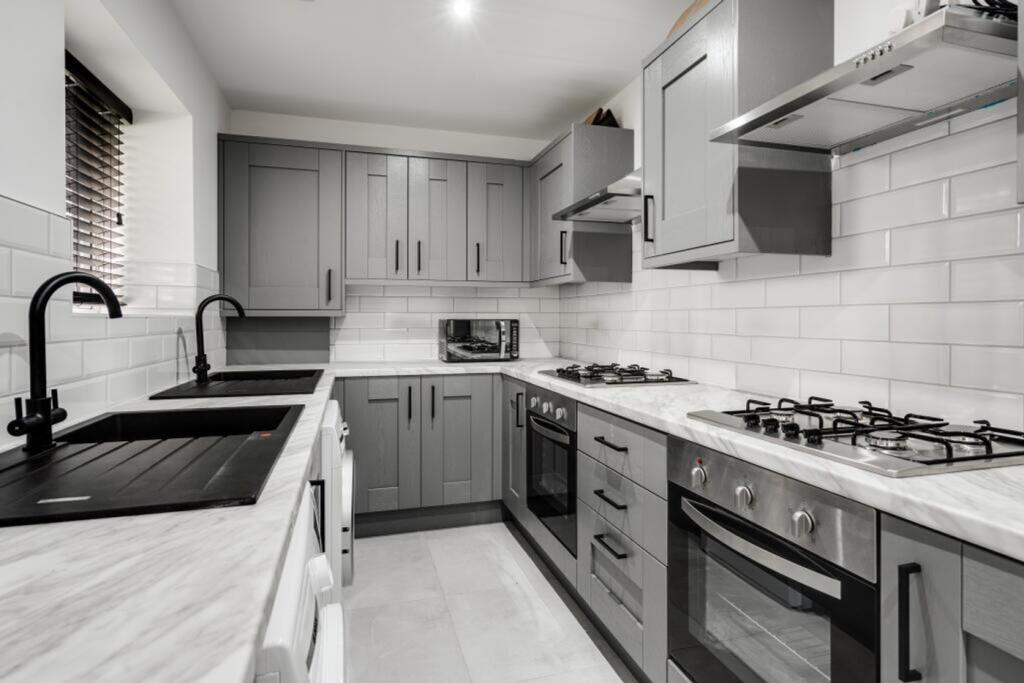 A modern and well-equipped kitchen featuring sl...