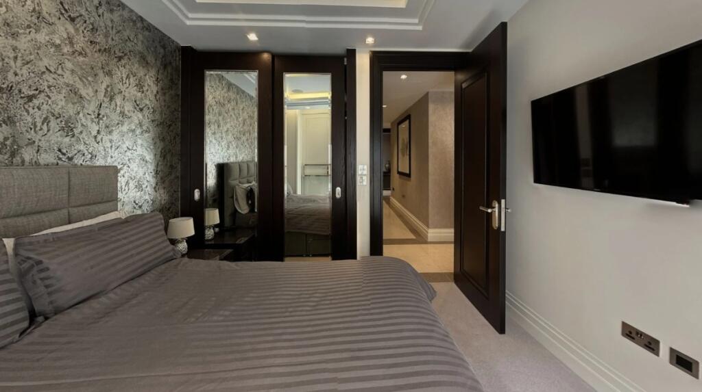A stylish double bedroom featuring a comfortabl...