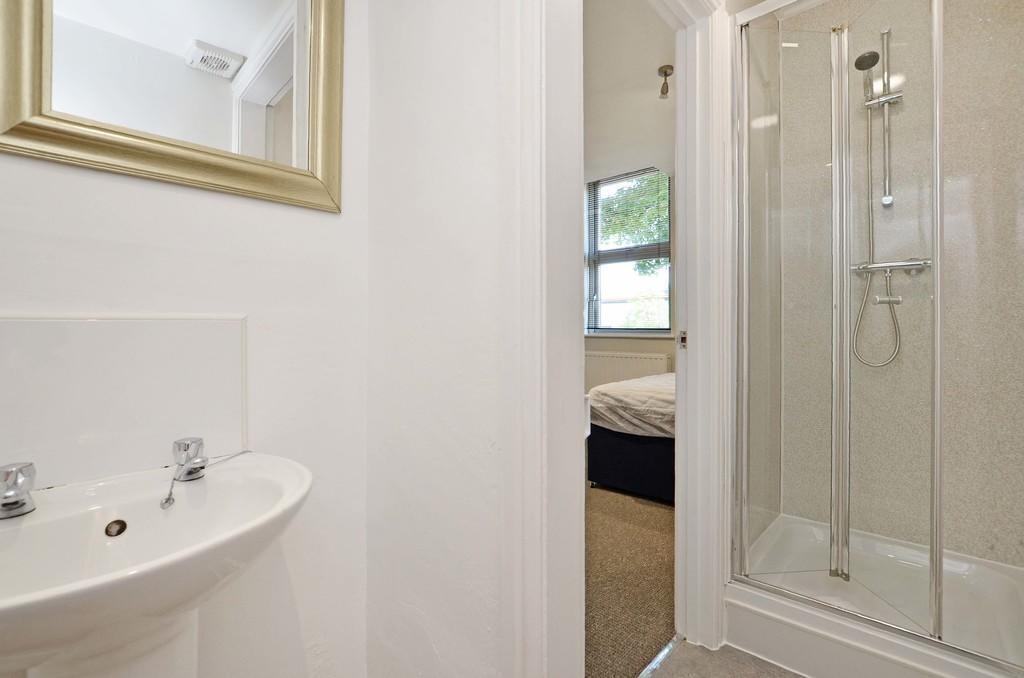 Bright and clean ensuite bathroom featuring a m...