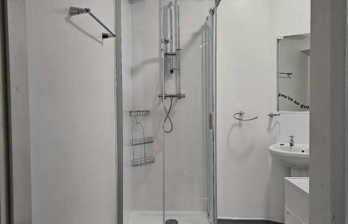 A clean and modern bathroom suite featuring a g...