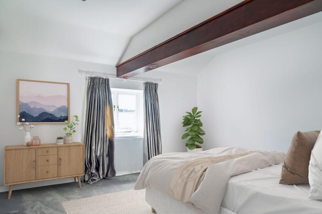 Bedroom 3 with exposed beams brimming with character