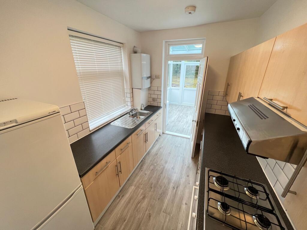 Bright and tidy galley kitchen featuring ample ...