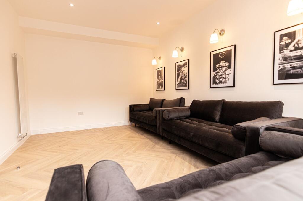 A spacious, well-lit contemporary living room f...