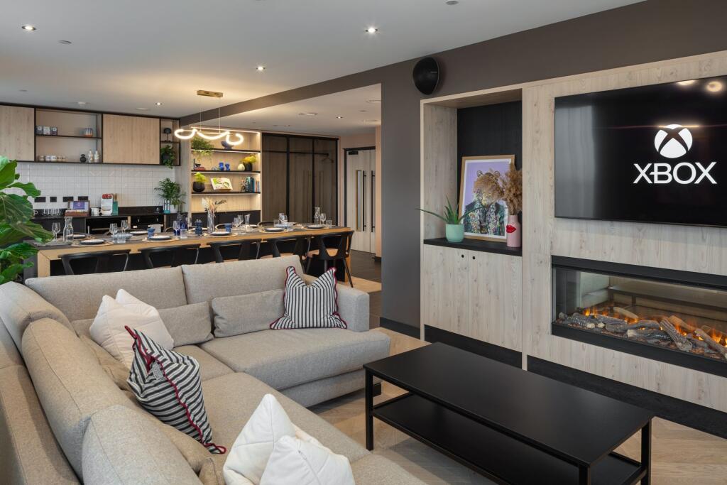 A modern and stylish living room featuring a sp...