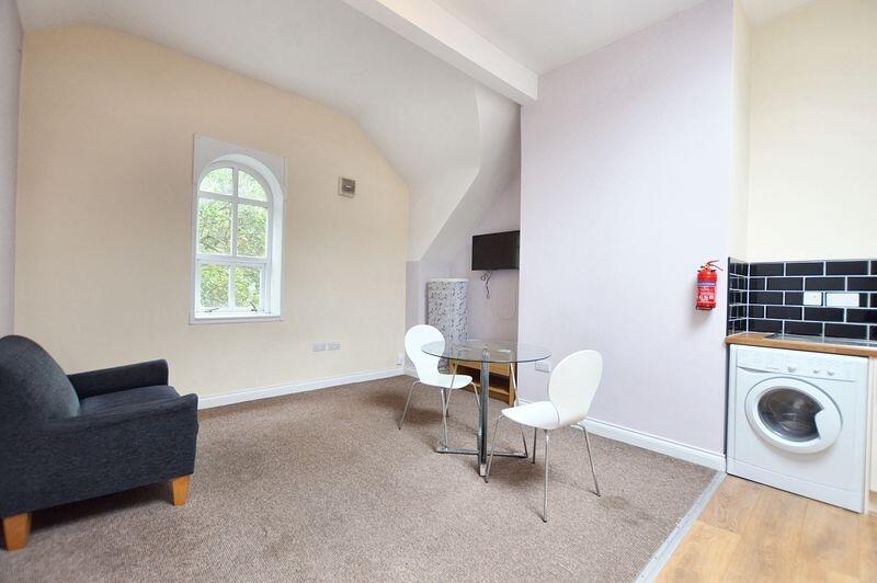 A bright and inviting living area featuring a c...