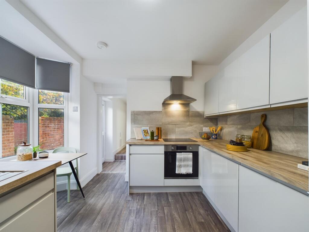 Bright and modern kitchen featuring ample natur...