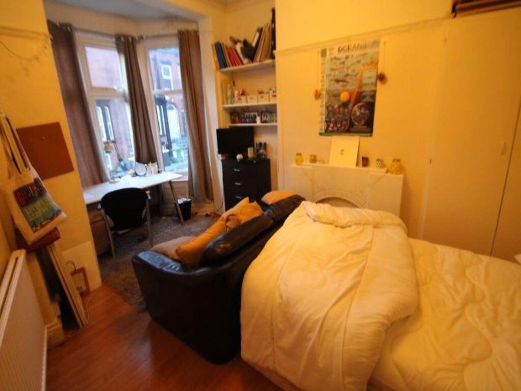 Cozy single bedroom with a comfortable bed, a d...