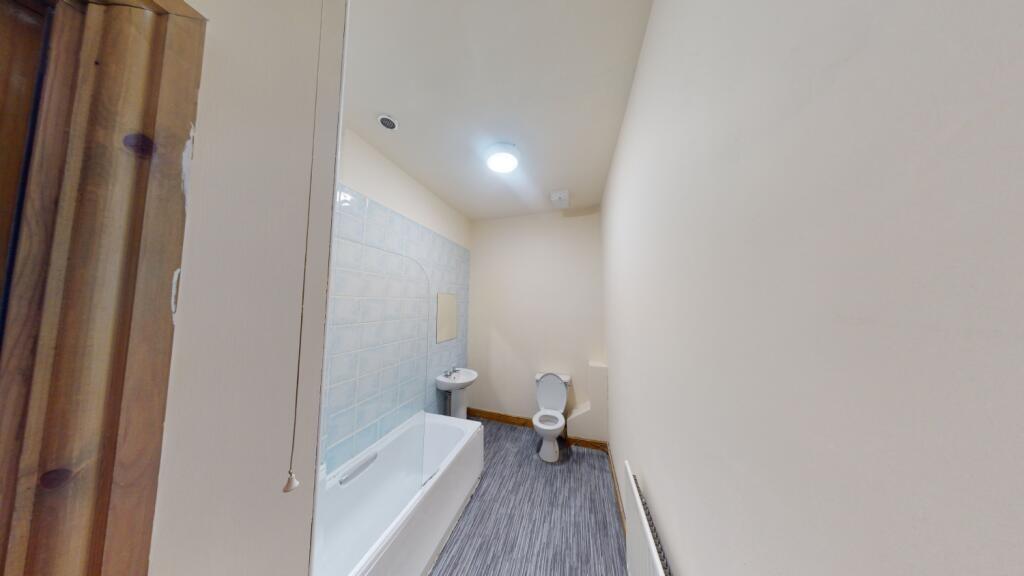 A clean and modern bathroom featuring a white b...